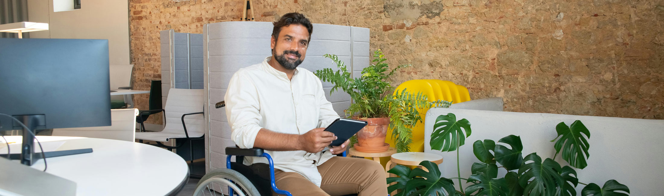 man in wheelchair holding notebook