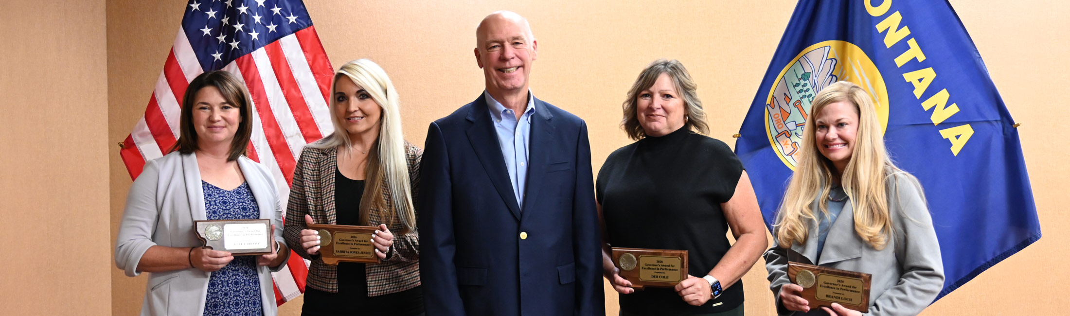 Governor Gianforte standing with DPHHS staff holding awards