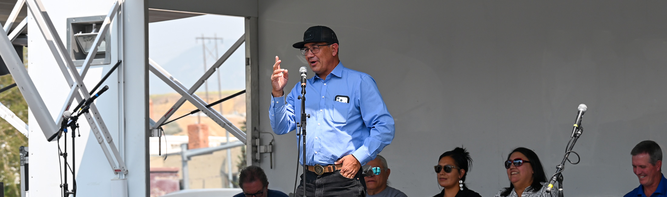 man speaking into microphone at event