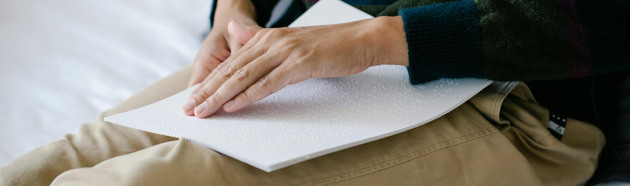 A hand reading braille.