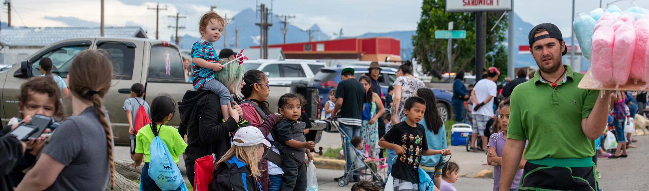 man selling cotton candy at street parade