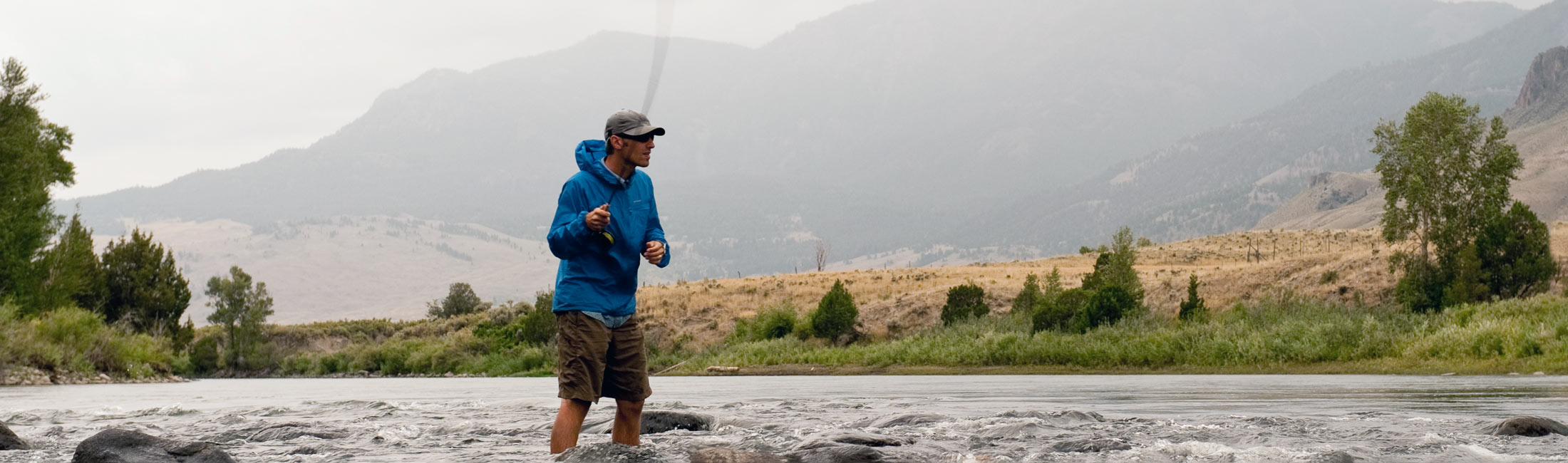 man in shorts fly fishing in Yellowstone River
